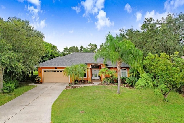 view of front of property with a front lawn and a garage