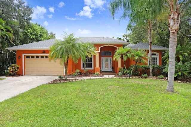 view of front of house featuring a garage and a front yard