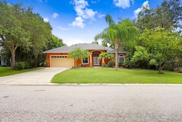 view of front of property featuring a garage and a front lawn