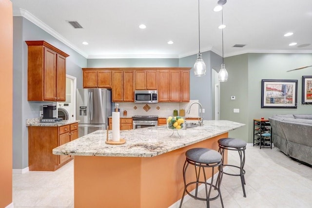 kitchen featuring crown molding, appliances with stainless steel finishes, light tile patterned flooring, and pendant lighting