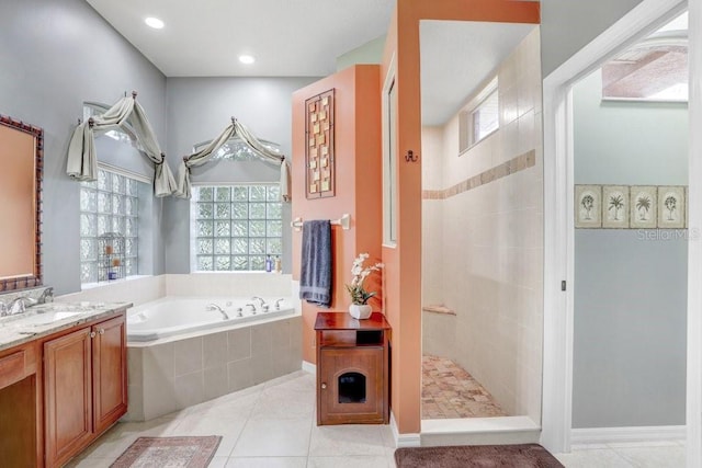 bathroom with tile patterned flooring, separate shower and tub, and vanity