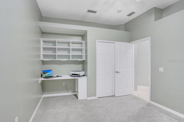 unfurnished office featuring carpet flooring and built in desk