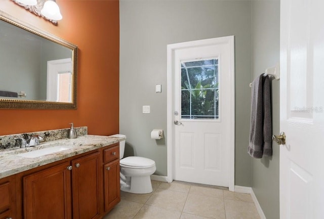 bathroom with tile patterned floors, vanity, and toilet