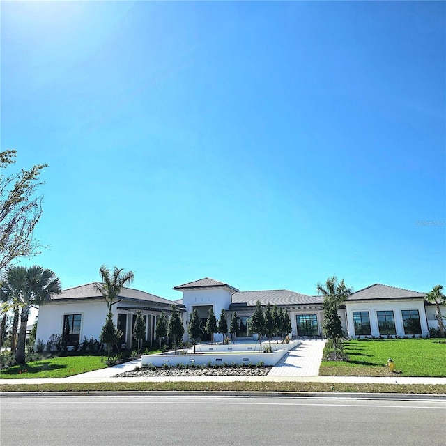 view of front of home featuring a front yard and stucco siding