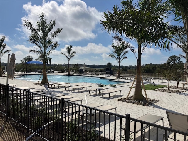 pool featuring fence and a patio