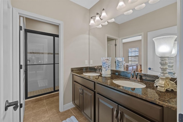 bathroom featuring a shower with shower door, tile patterned floors, and double sink vanity