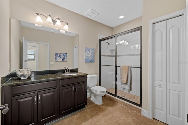 bathroom with a shower with shower door, tile patterned floors, toilet, and vanity