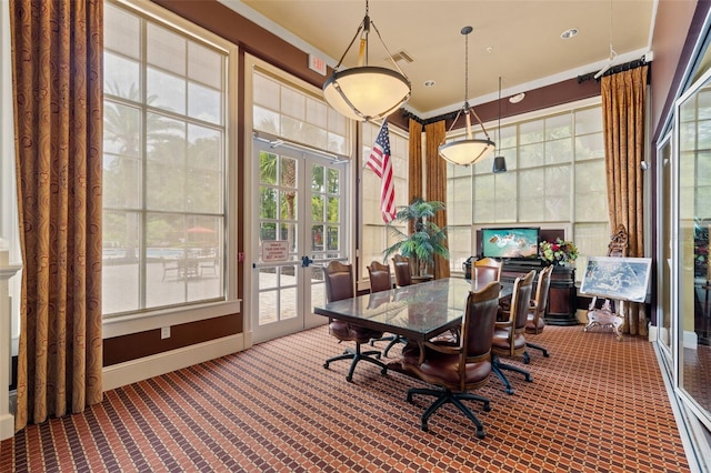 dining room with ornamental molding, french doors, and carpet flooring