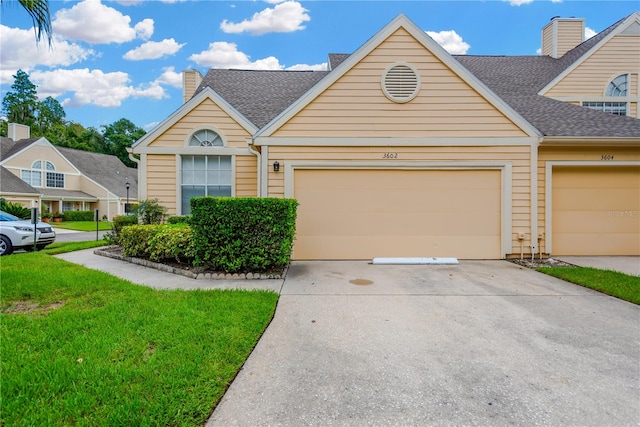 view of front of property with a garage and a front yard