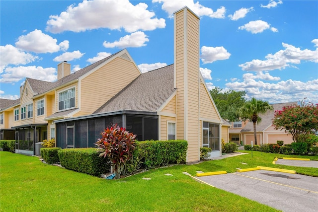 view of property exterior with a sunroom and a lawn