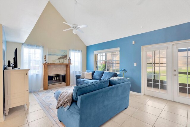 living room with high vaulted ceiling, french doors, ceiling fan, and light tile patterned floors