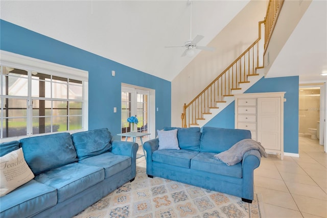 living room featuring light tile patterned floors, ceiling fan, and high vaulted ceiling