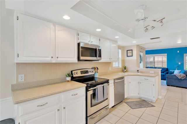 kitchen featuring white cabinetry, stainless steel appliances, light tile patterned flooring, and ceiling fan