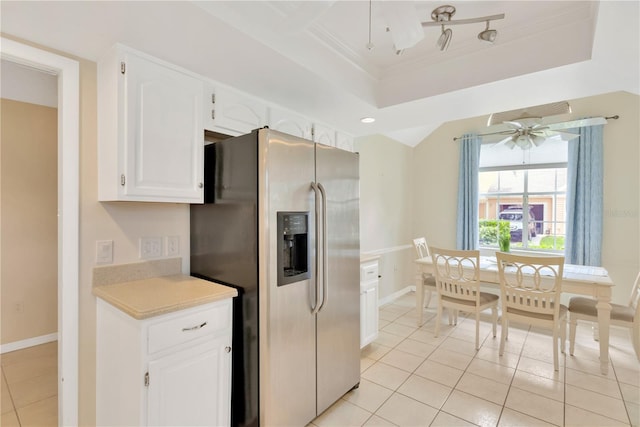 kitchen with stainless steel refrigerator with ice dispenser, white cabinets, a raised ceiling, and ceiling fan