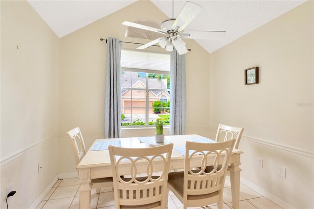 dining area featuring ceiling fan, lofted ceiling, and light tile patterned floors