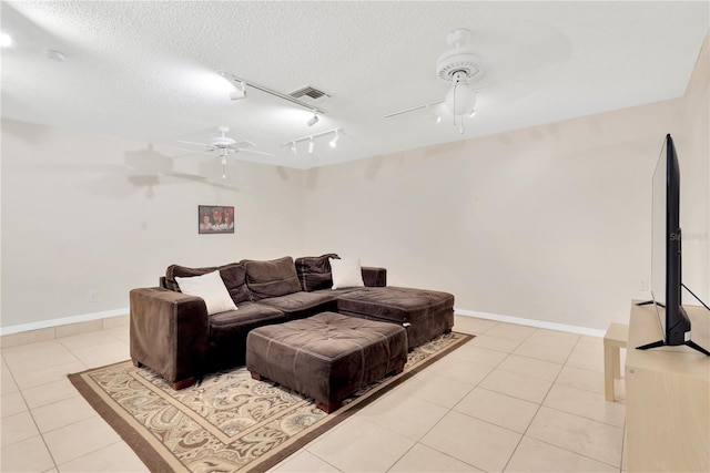 living room featuring light tile patterned flooring, a textured ceiling, ceiling fan, and track lighting