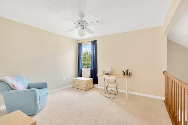 sitting room featuring carpet, a textured ceiling, and ceiling fan