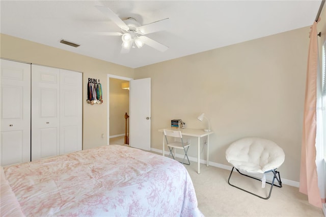 carpeted bedroom featuring ceiling fan and a closet