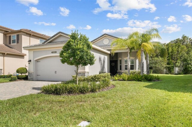 view of front of house with a garage and a front lawn