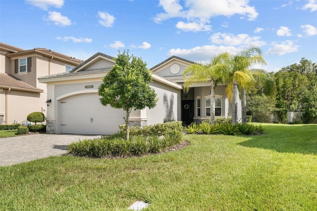 view of front facade with a garage and a front lawn