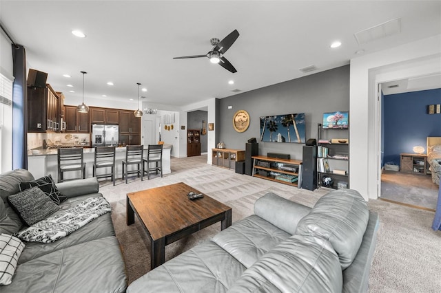 carpeted living room featuring ceiling fan