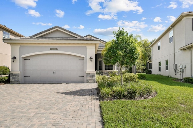 view of front of home with a garage and a front lawn