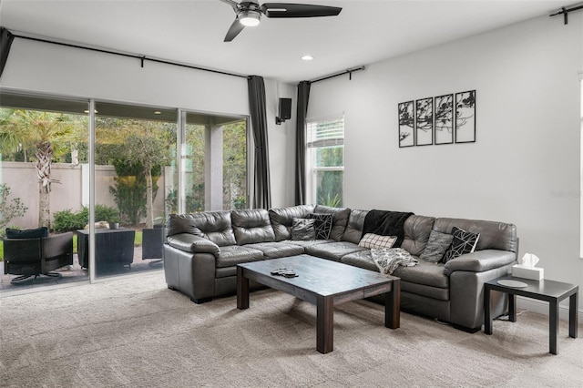 living room featuring light colored carpet and ceiling fan