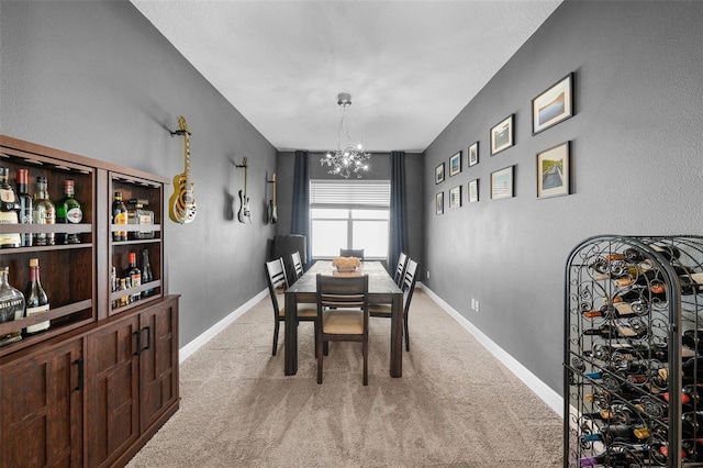 carpeted dining area with a chandelier