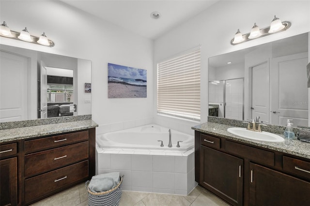 bathroom featuring plus walk in shower, tile patterned floors, and vanity