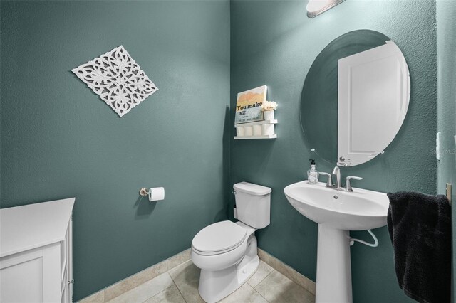 bathroom featuring sink, tile patterned floors, and toilet