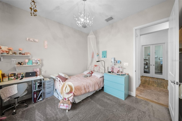 bedroom featuring carpet, a chandelier, and french doors