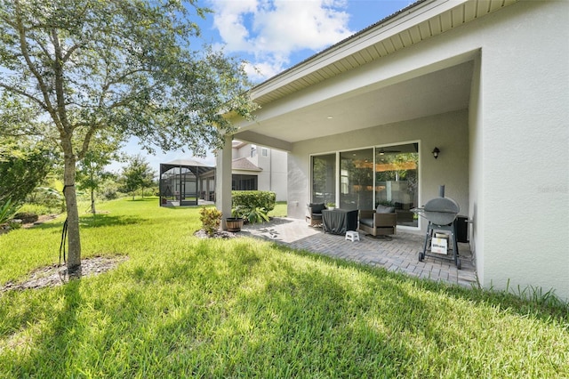 view of yard featuring a patio area and glass enclosure