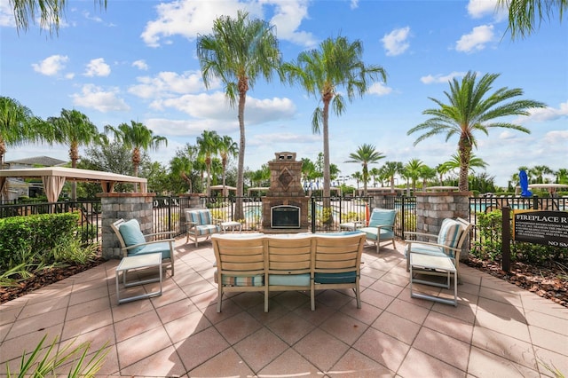 view of patio / terrace with an outdoor living space with a fireplace