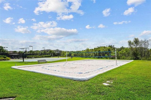 view of property's community with a yard and volleyball court