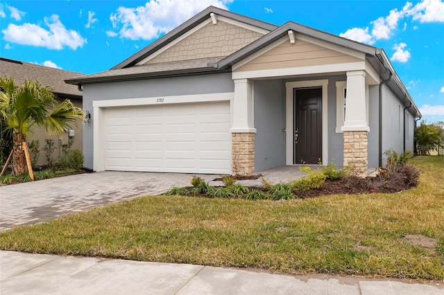 view of front of property with a garage and a front yard