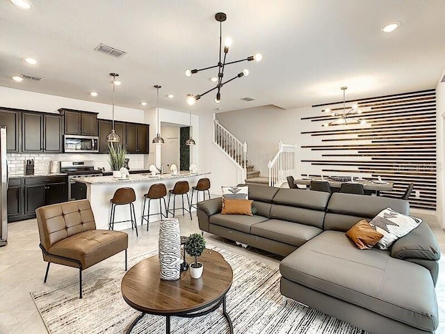 living room featuring a chandelier and light tile patterned floors