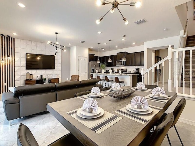 dining area featuring an inviting chandelier and light tile patterned floors