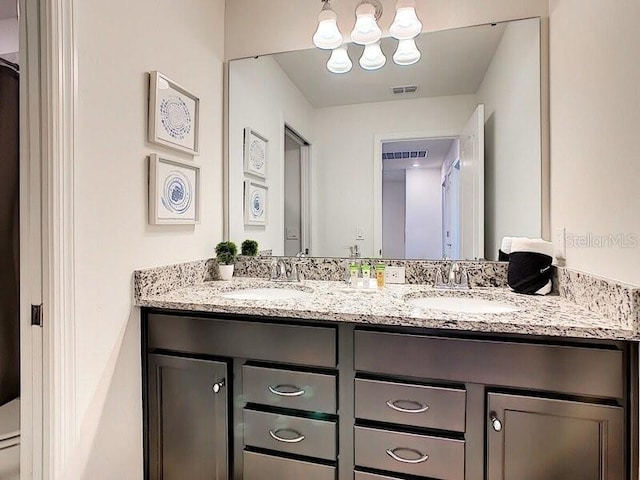 7472 Oakmoss Loop, Davenport, FL 33837 - full bath with double vanity, a chandelier, and toilet