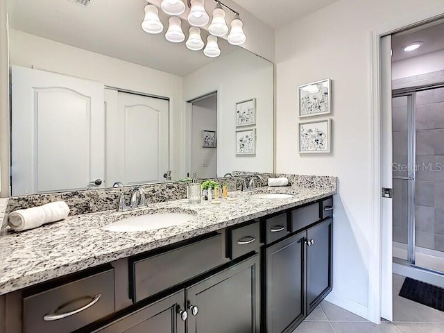 bathroom with tile patterned floors, an enclosed shower, and vanity