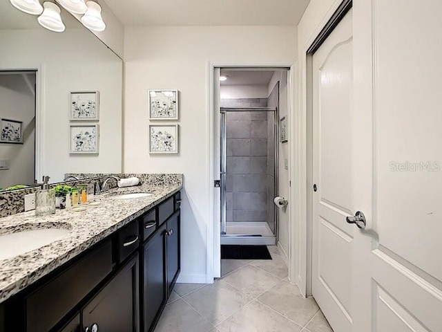 7472 Oakmoss Loop, Davenport, FL 33837 - full bath with tile patterned floors, double vanity, a stall shower, and baseboards