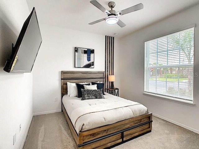 7472 Oakmoss Loop, Davenport, FL 33837 - bedroom featuring light colored carpet, baseboards, and a ceiling fan