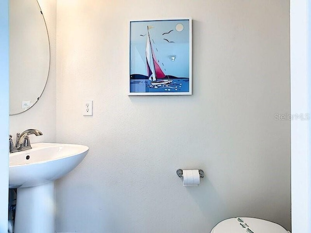 7472 Oakmoss Loop, Davenport, FL 33837 - bathroom with toilet and a sink