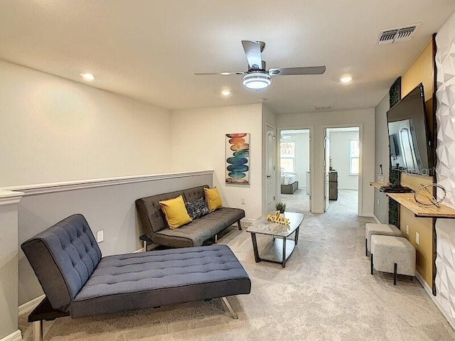 sitting room with light colored carpet and ceiling fan