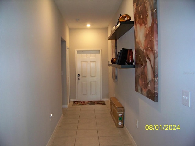 hall featuring light tile patterned floors