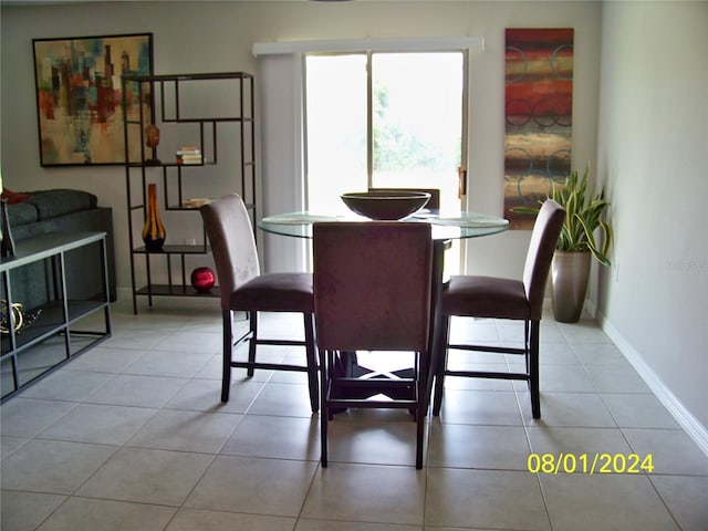 dining space featuring light tile patterned floors