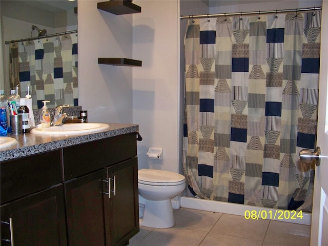 bathroom featuring tile patterned flooring, vanity, and toilet