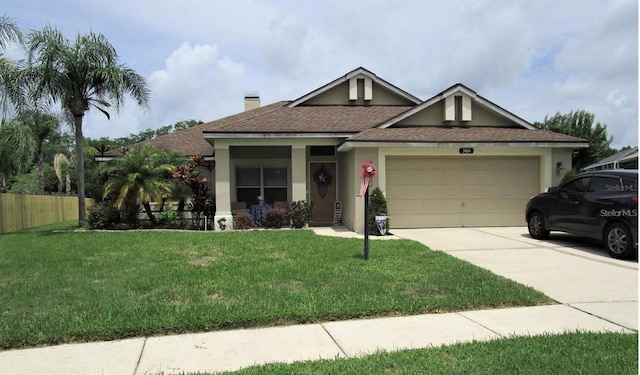 view of front of home with a garage and a front lawn