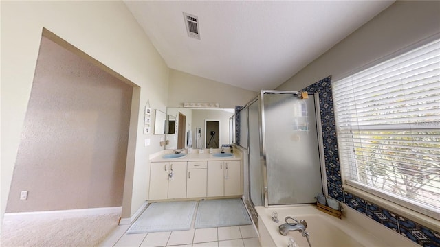 bathroom with tile patterned floors, lofted ceiling, vanity, and separate shower and tub