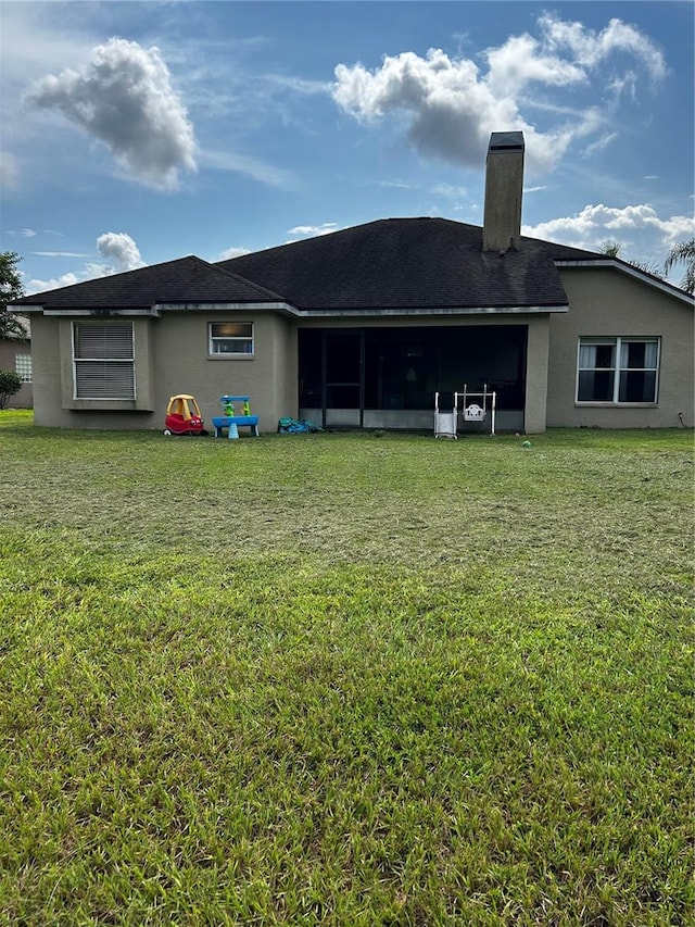 rear view of property with a yard