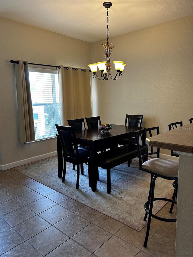 dining space with a notable chandelier and tile patterned floors